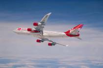 This Sunday, April 12, 2020 photo provided by Virgin Orbit shows a Boeing 747 with a rocket slu ...