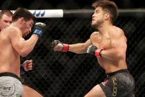 Henry Cejudo, right, punches Dominick Cruz during a UFC 249 mixed martial arts bout, Saturday, ...