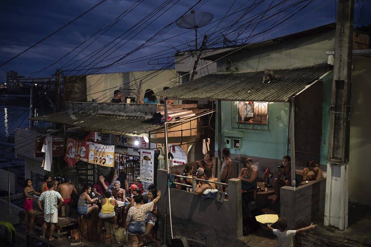 People gather outside a bar in Manaus, Brazil, Sunday, May 24, 2020, amid the new coronavirus p ...