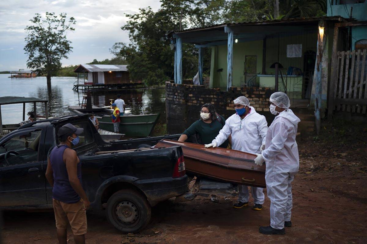 SOS Funeral workers move a coffin holding the body of an 86-year-old woman who lived by the Neg ...