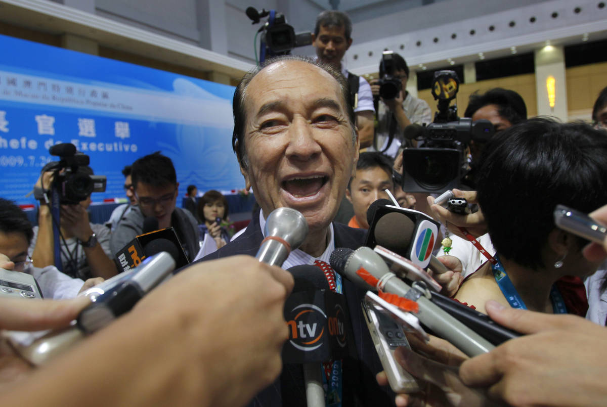 Macao tycoon Stanley Ho talks to reporters after the Macau chief executive election in Macao, J ...