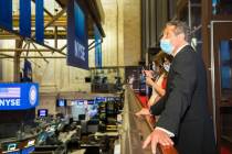 In this image provided by the New York Stock Exchange, New York State Gov. Andrew Cuomo looks o ...