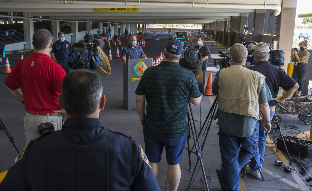 Clark County Commissioner Jim Gibson, center, speaks during a media briefing followed by a walk ...