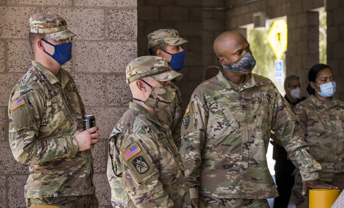 Nevada National Guard troops listen in during the Clark County media briefing and walk through ...