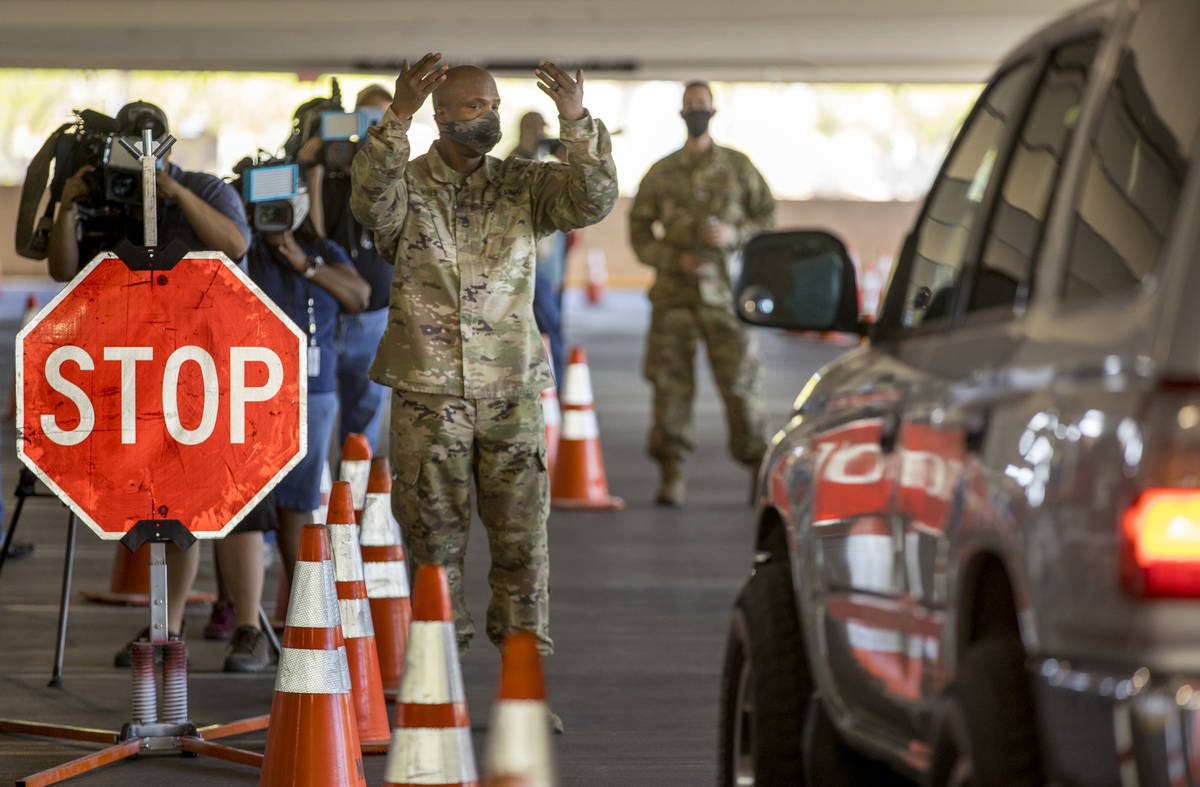 A Nevada National Guard soldier directs a drive-thru demonstration following the Clark County m ...