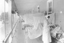 FILE - In this November 1918 photo made available by the Library of Congress, a nurse takes the ...