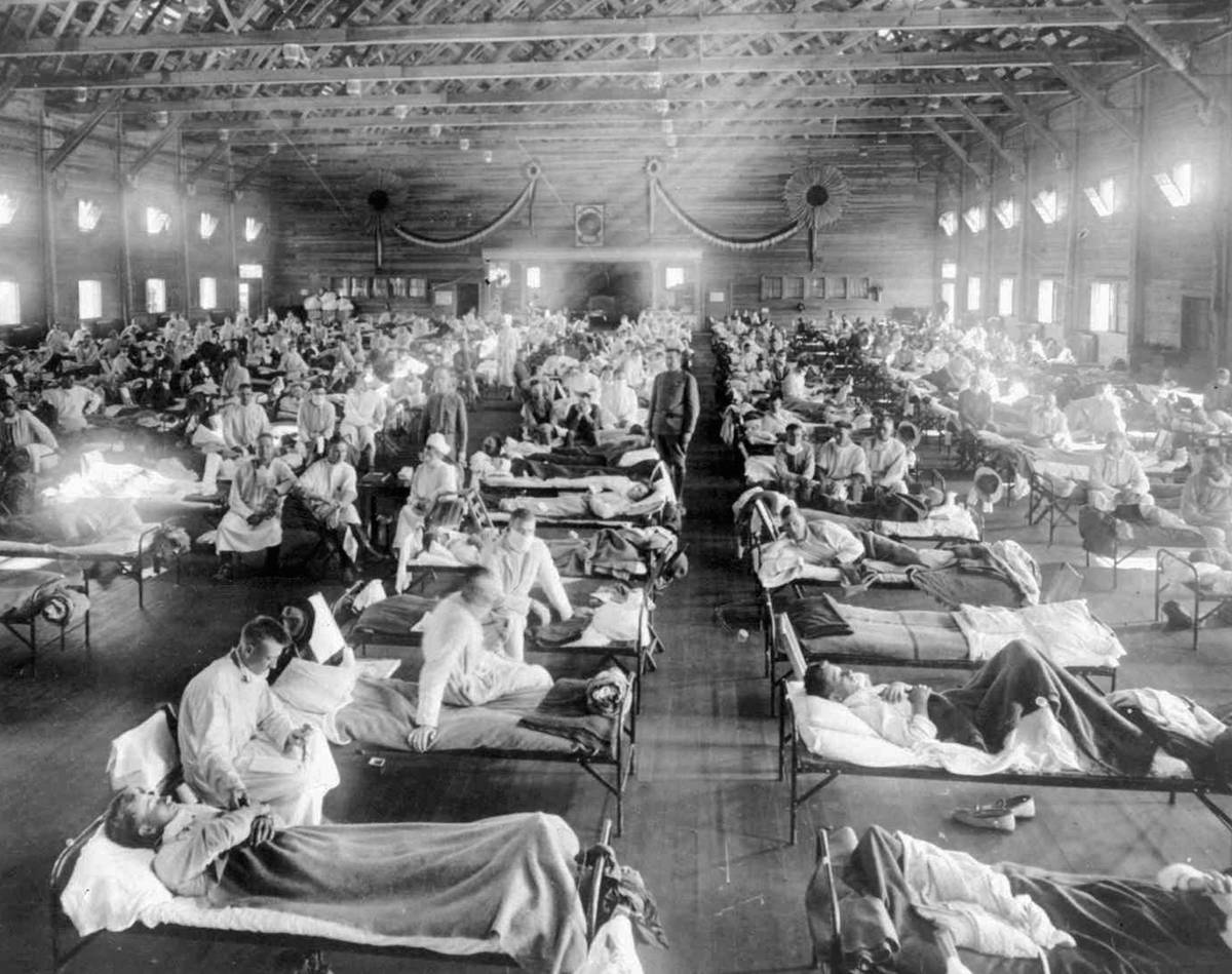 ** FILE ** In this 1918 photograph, influenza victims crowd into an emergency hospital at Camp ...