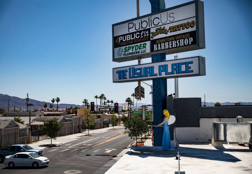 Victoria Hogan, dressed as the Blue Angel statue from the former Blue Angel Motel, stands on to ...