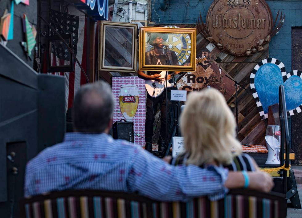 Singer-songwriter Jowzay performs behind protective shields to a socially distant crowd at ReBa ...