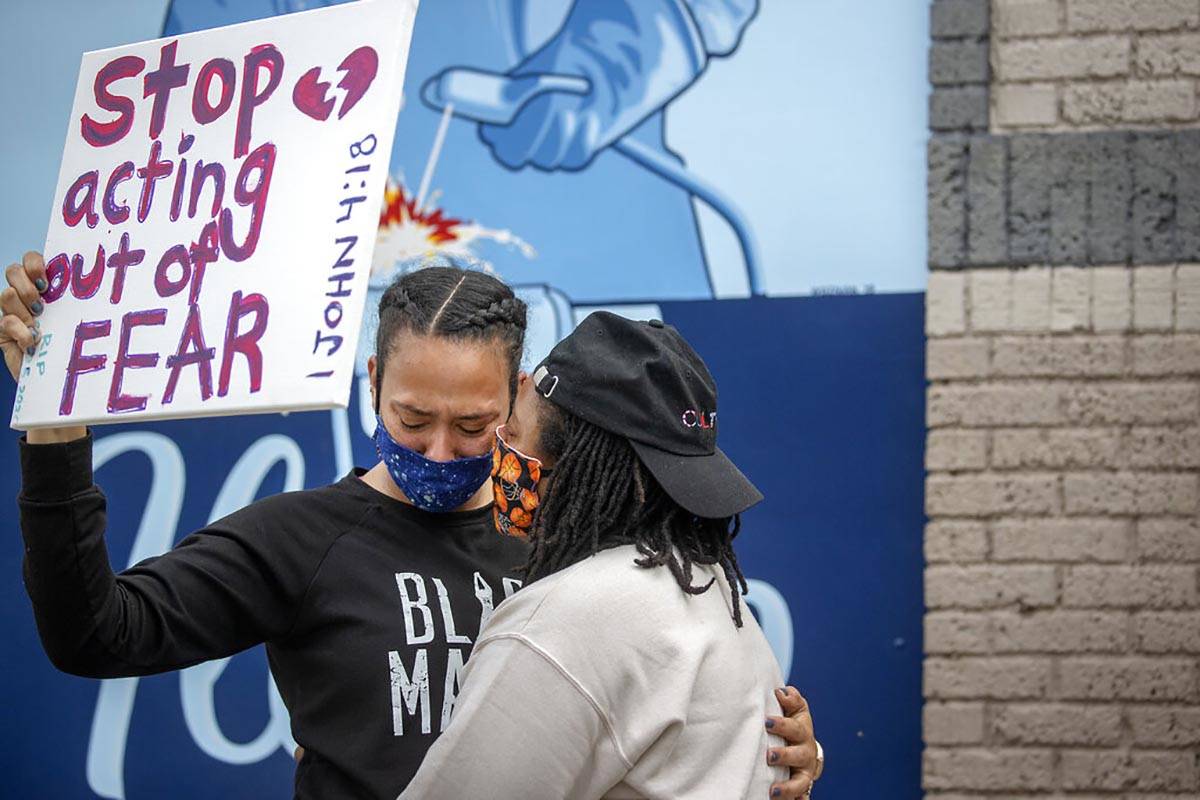 Asha Knight, left, is comforted by Dilonna Johnson, Tuesday, May 26, 2020, in Minneapolis, near ...