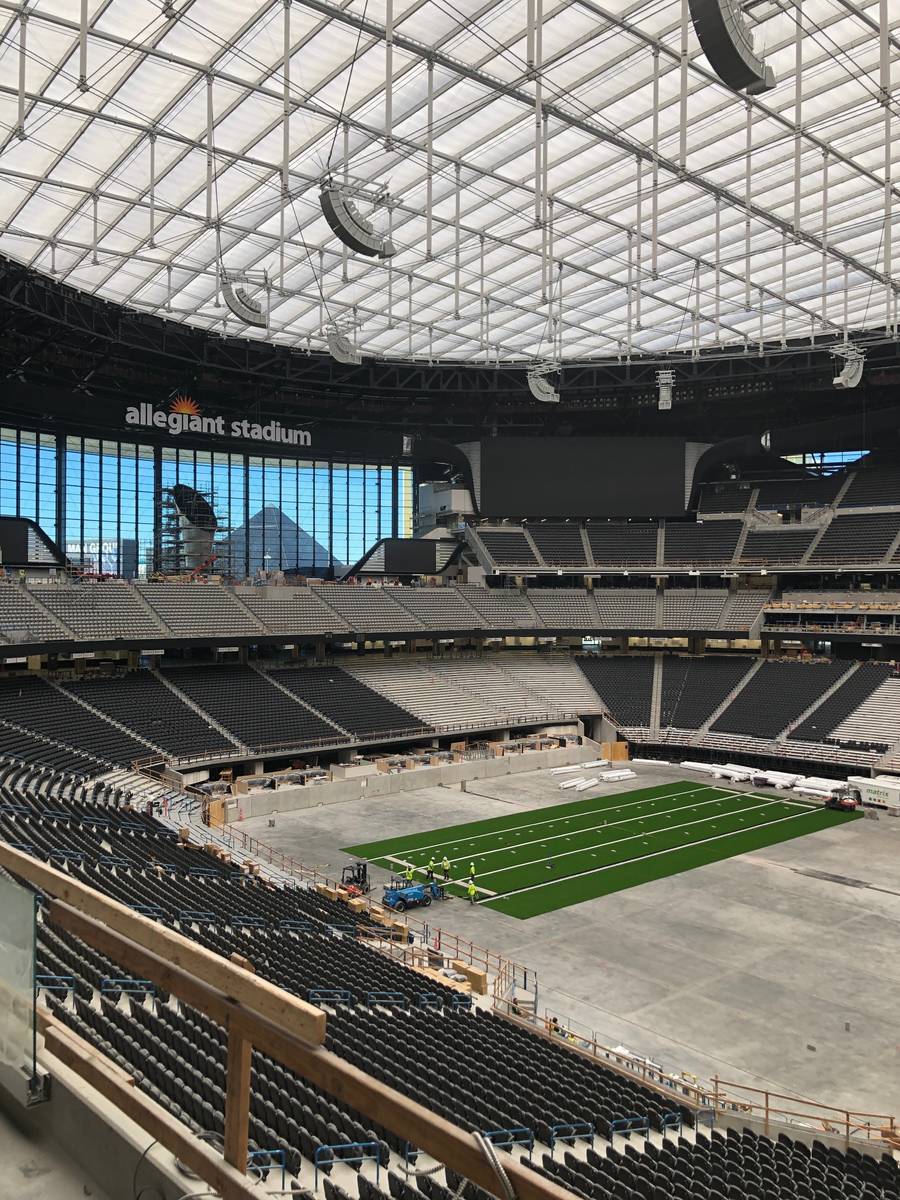 Crews installing the artificial turf that UNLV football will play its home games on in Allegian ...