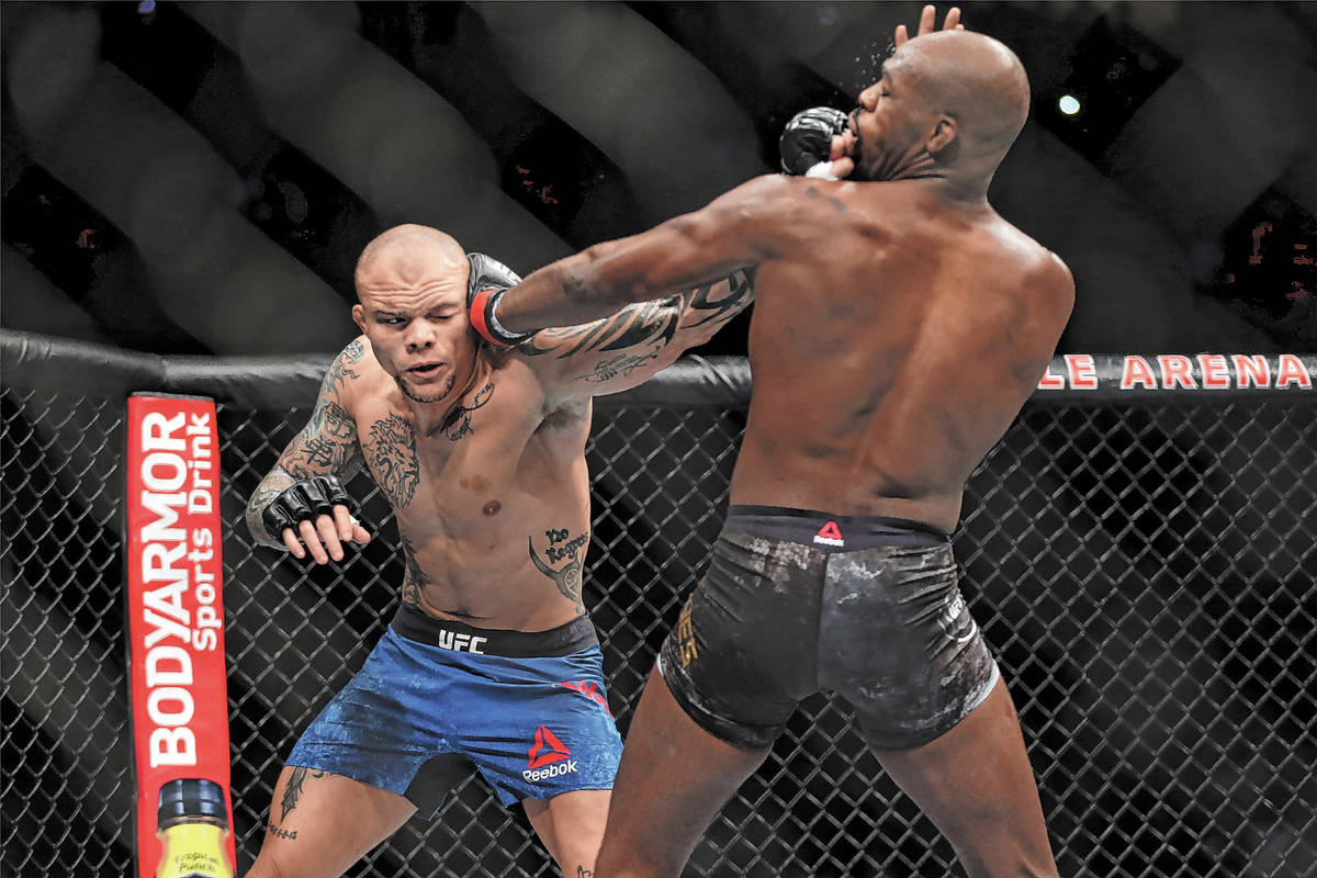 Anthony Smith, left, battles Jon Jones in the light heavyweight title bout during UFC 235 at T- ...