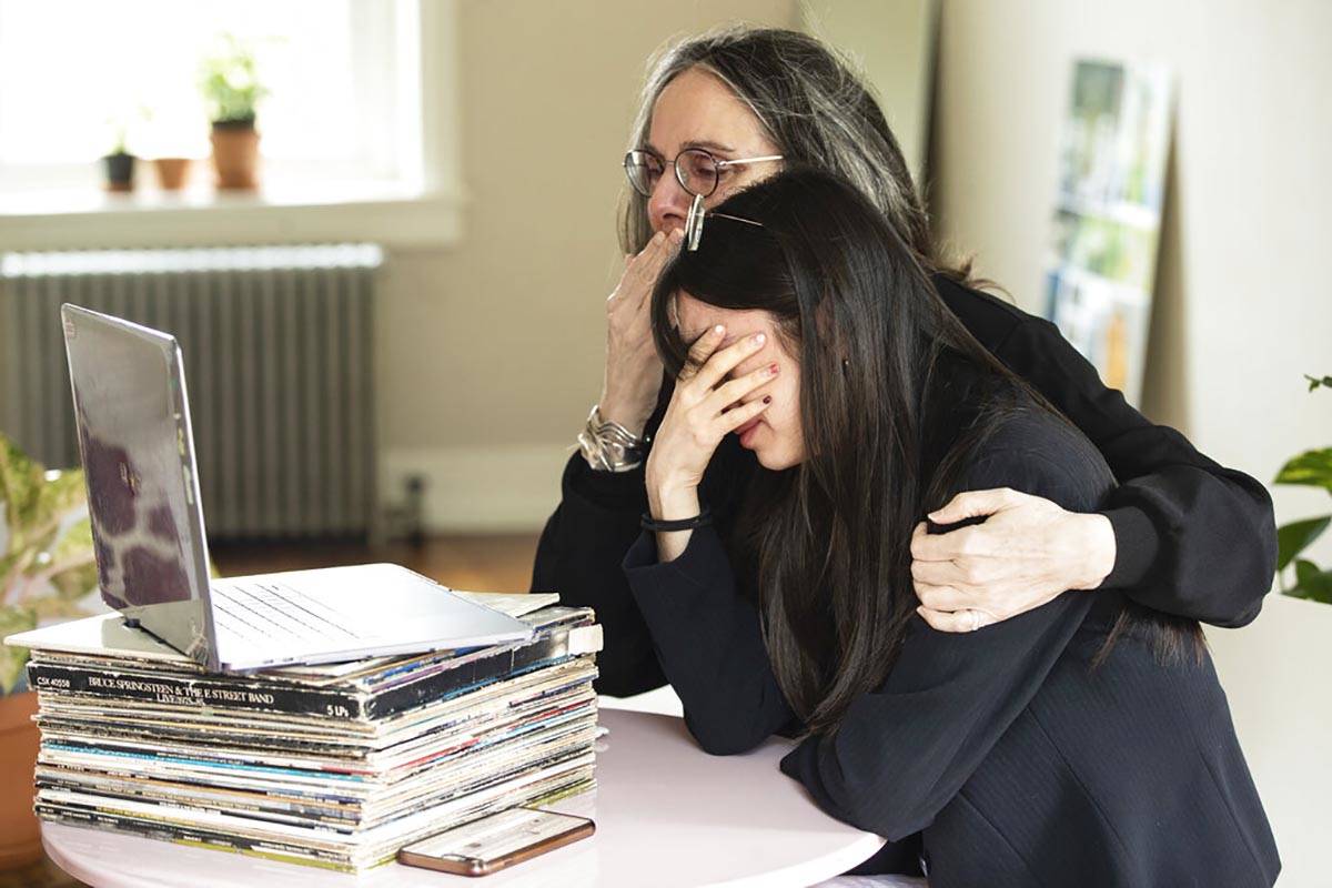 In this April 29, 2020, file photo, Beth Pardo and her daughter Zoe Ko view a burial service fo ...