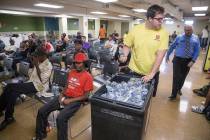 Shelter monitor Boston Brimhall, left, and homeless services coordinator Ryan McDonald hand out ...