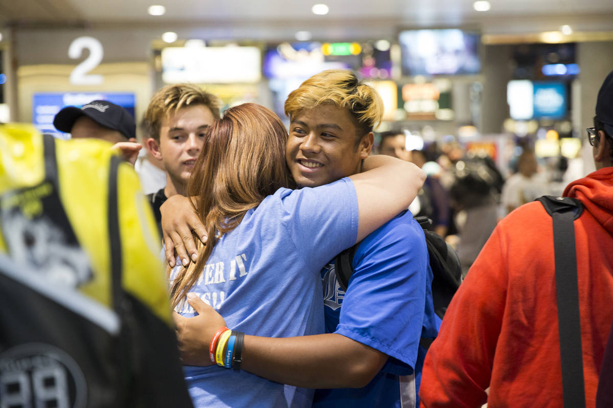 Jaime Riley, left, a mother of a player in the Southern Nevada Blue Sox baseball team, hugs tea ...