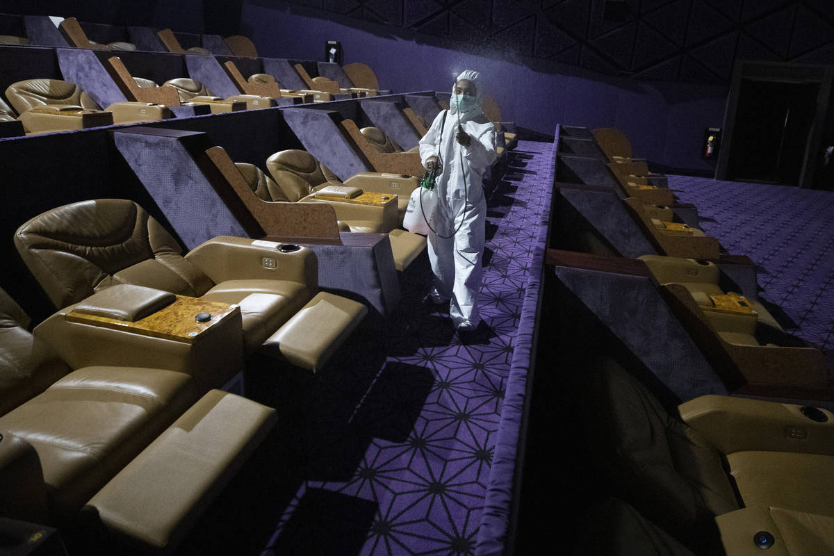 A worker sprays disinfectant as a precaution against the new coronavirus at Quartier Cineart mo ...