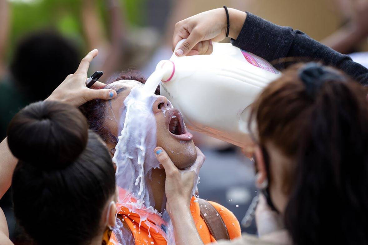 A protester is doused with milk after exposure to tear gas outside the Minneapolis Police 3rd P ...