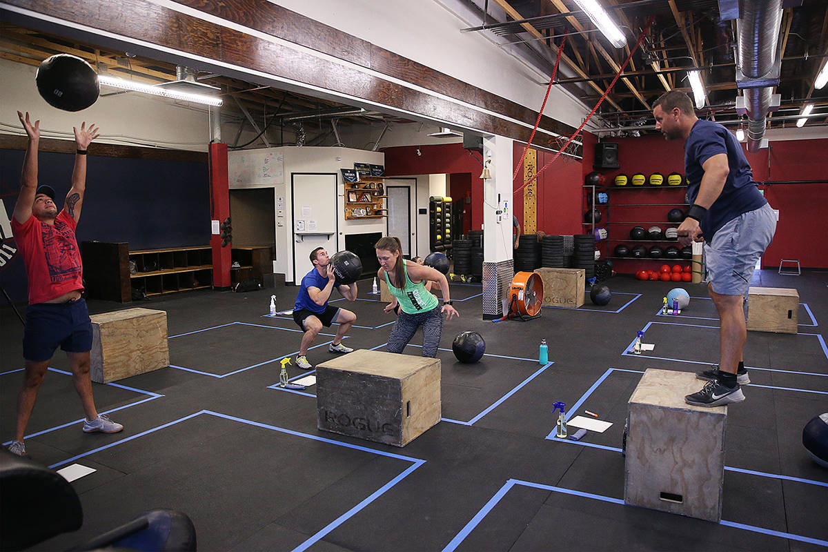 People workout while maintaining social distance during the first class after the state shutdow ...