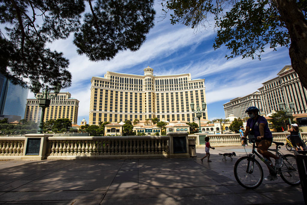 People take in the sights outside of the Bellagio along the Las Vegas Strip on Thursday, April ...