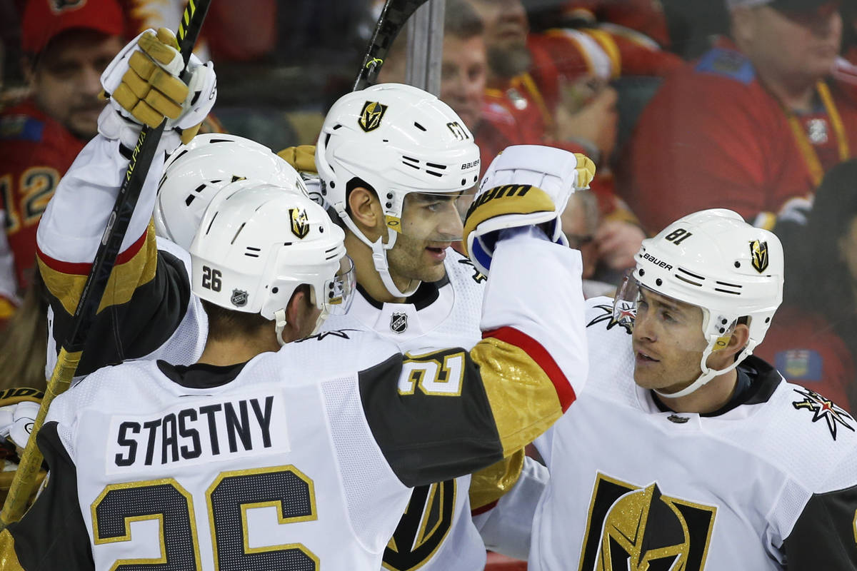 Vegas Golden Knights' Max Pacioretty, center, celebrates his goal with teammates Paul Stastny, ...