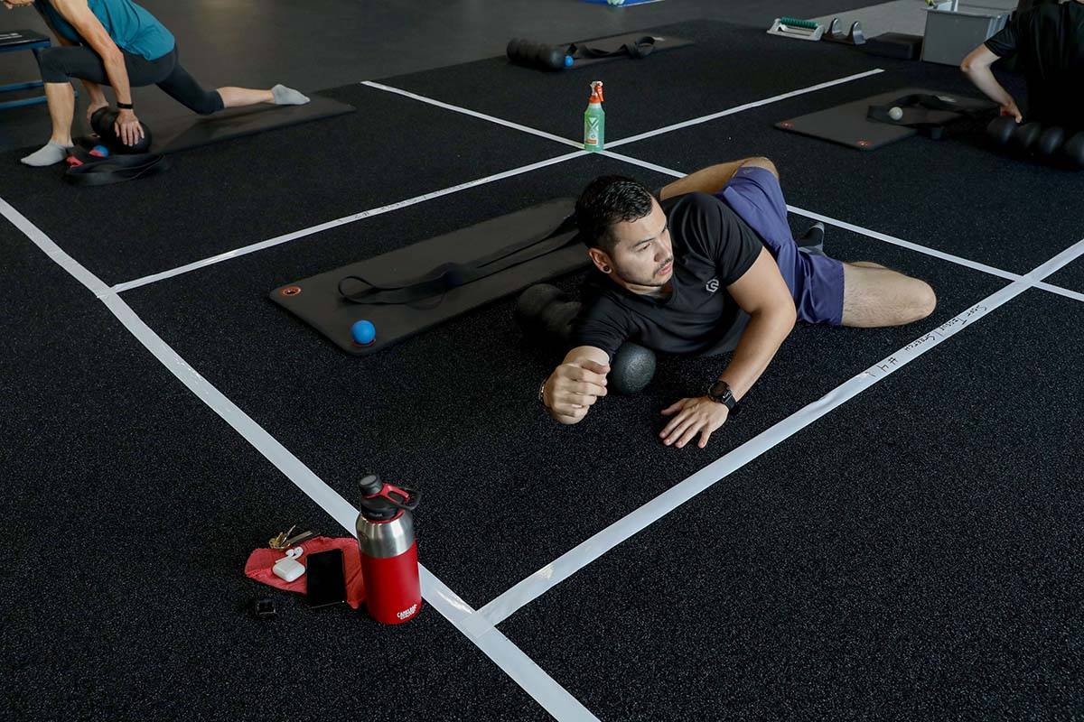 Brian Lee, member of The Gym Las Vegas, stretches while following social distancing guidelines ...