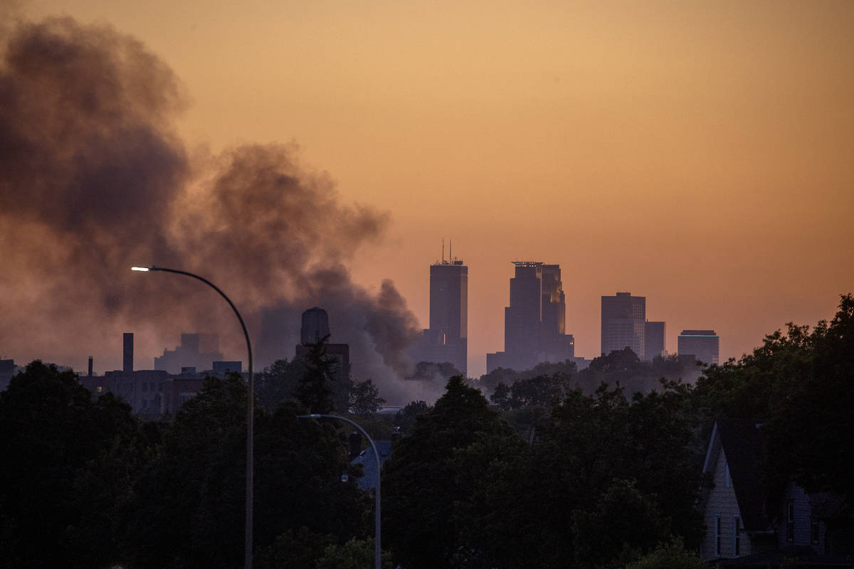 The sun set over the Twin Cities as smoke hovers over St. Paul, Minn., along University Avenue, ...