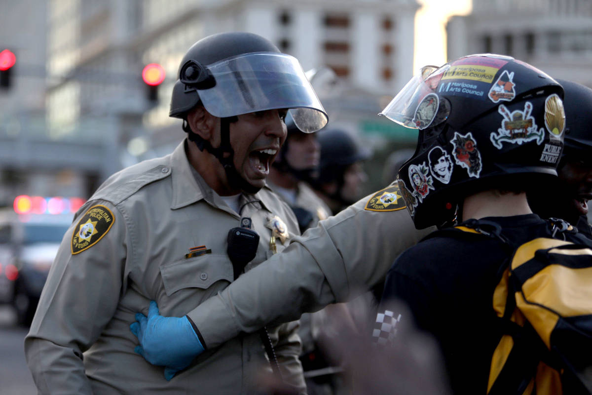 Demonstrators face off against police while demanding justice for George Floyd along the Las Ve ...