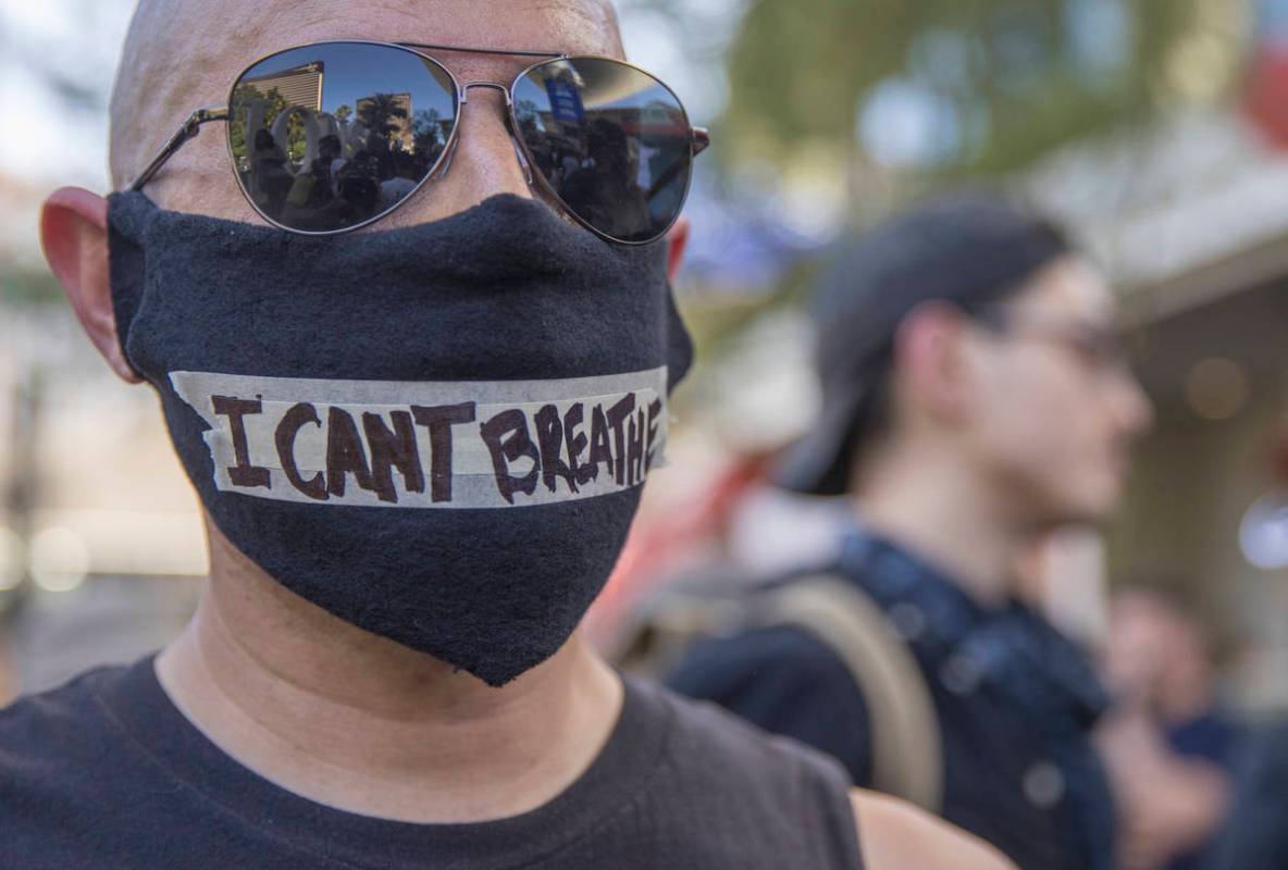 A man in mask during a Black Lives Matter protest and march along the along the Las Vegas Strip ...