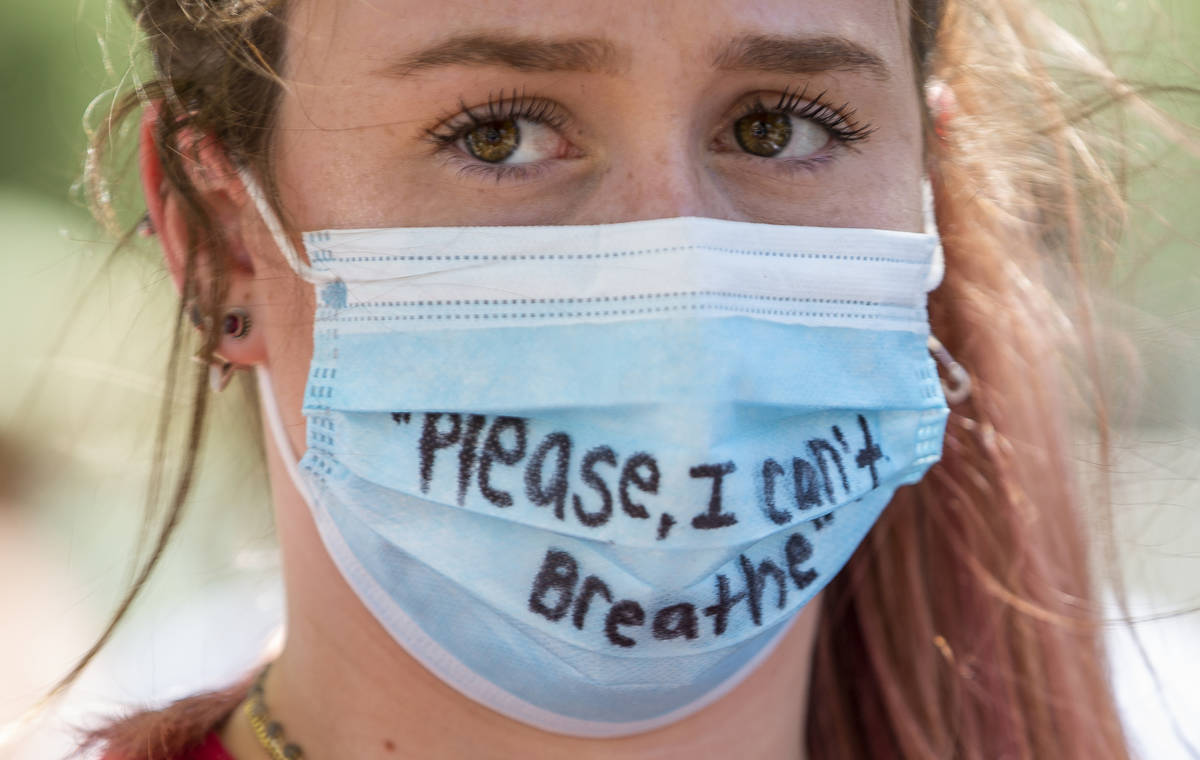 Protestor Sydney Belmonte with her signed mask near the Bellagio Fountains during a Black Lives ...