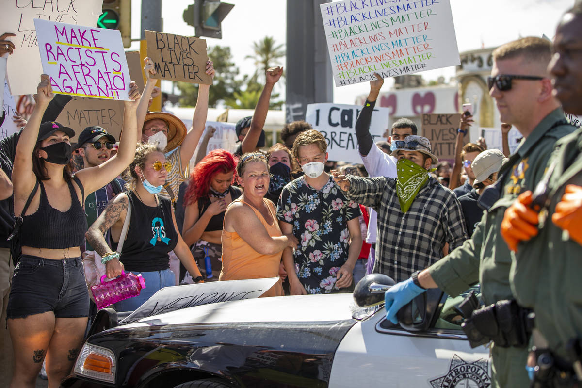 Protestors link arms while confronting the Las Vegas Police near Circus Circus during a Black L ...