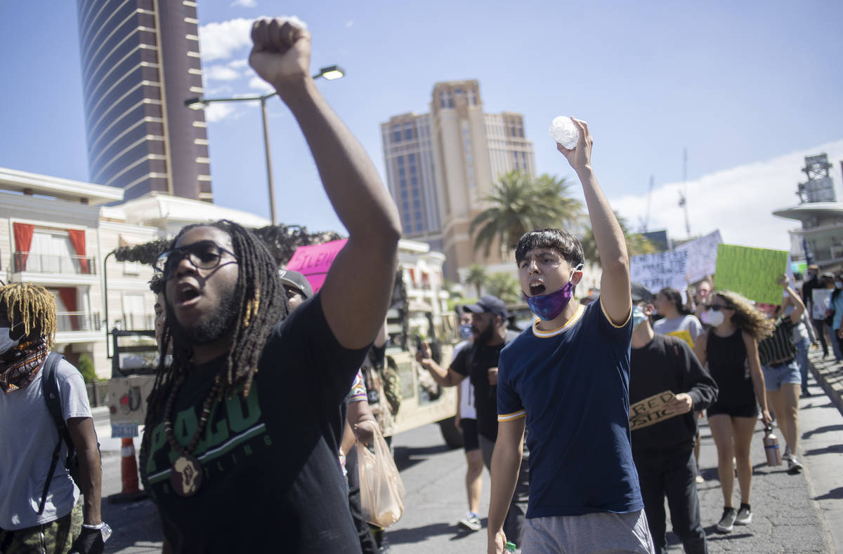 Supporters and members of the Black Lives Matter movement march down Las Vegas Boulevard in sol ...