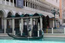 Pool maintenance worker Armando Felix cleans the outdoor canal at The Venetian on the Strip in ...