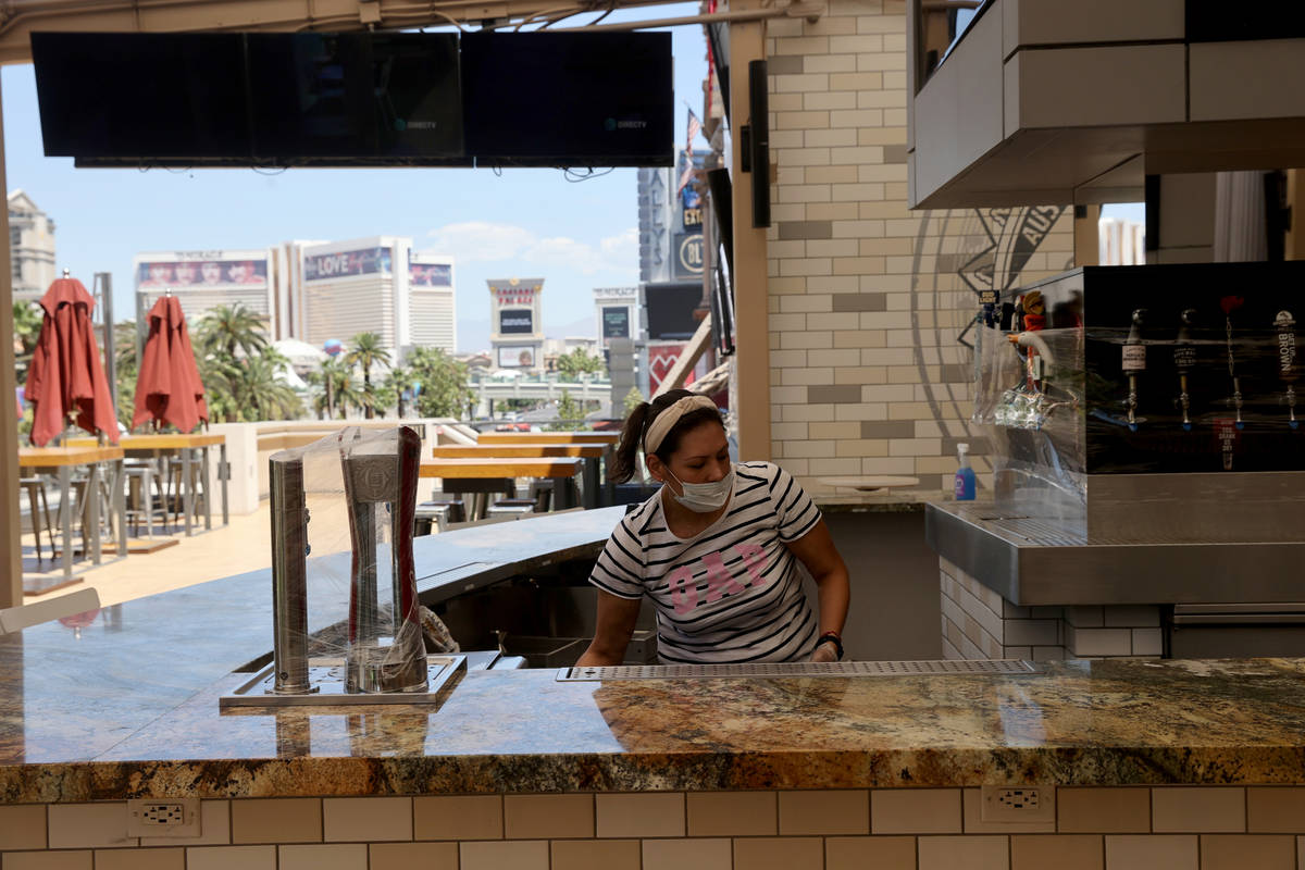 Gabriela Martinez cleans a bar at Beer Park at Paris Las Vegas on the Strip Thursday, May 28, 2 ...