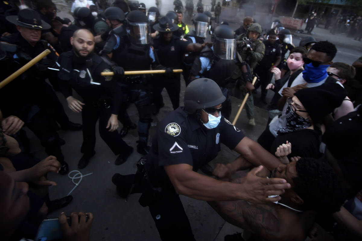 Police officers and protesters clash near CNN Center, Friday, May 29, 2020, in Atlanta, in resp ...