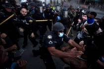 Police officers and protesters clash near CNN Center, Friday, May 29, 2020, in Atlanta, in resp ...