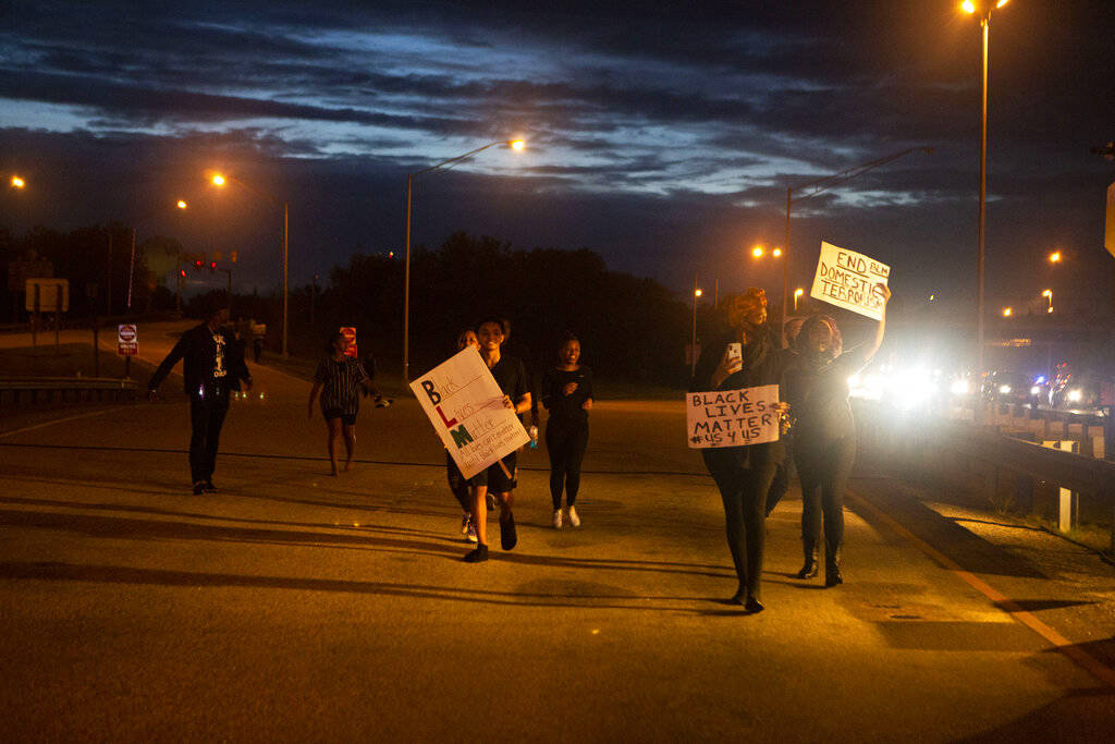 Protestors enter I-64 eastbound in preparation to shutting down Interstate 64, Friday, May 29, ...