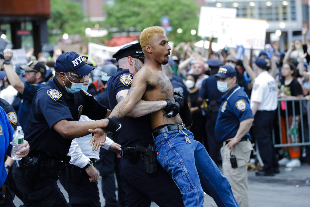 A protester is arrested during a rally at the Barclays Center over the death of George Floyd, a ...