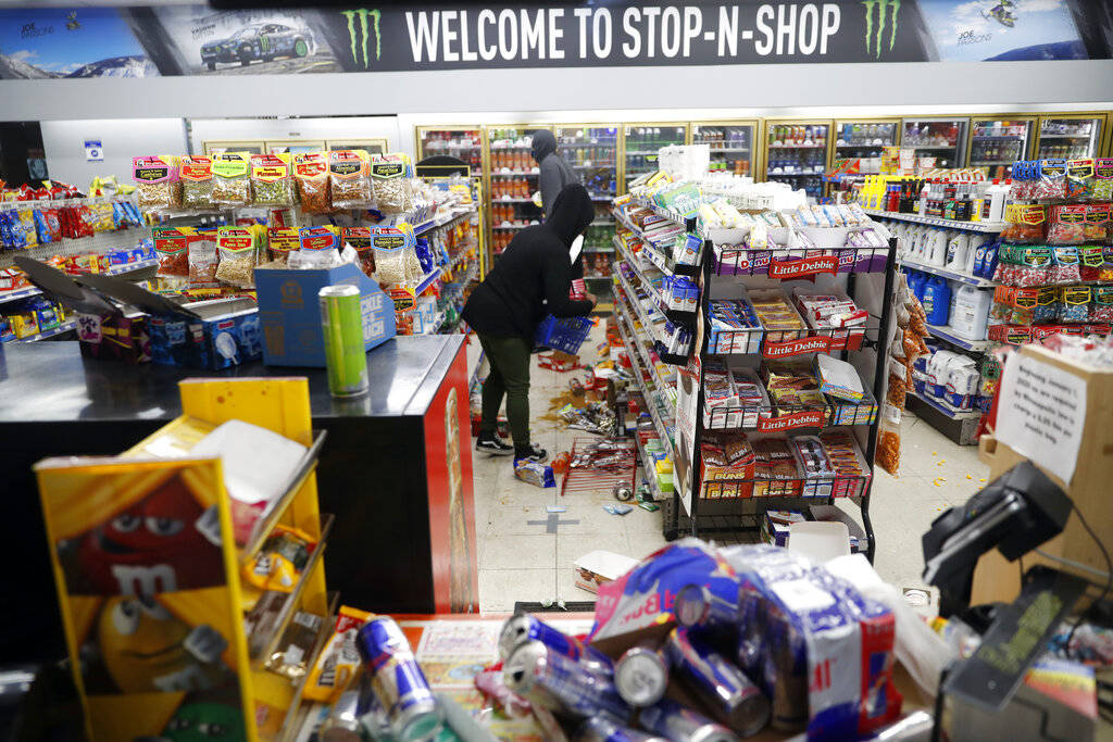 People loot a convenience store Friday, May 29, 2020, in Minneapolis. Protests continued follow ...