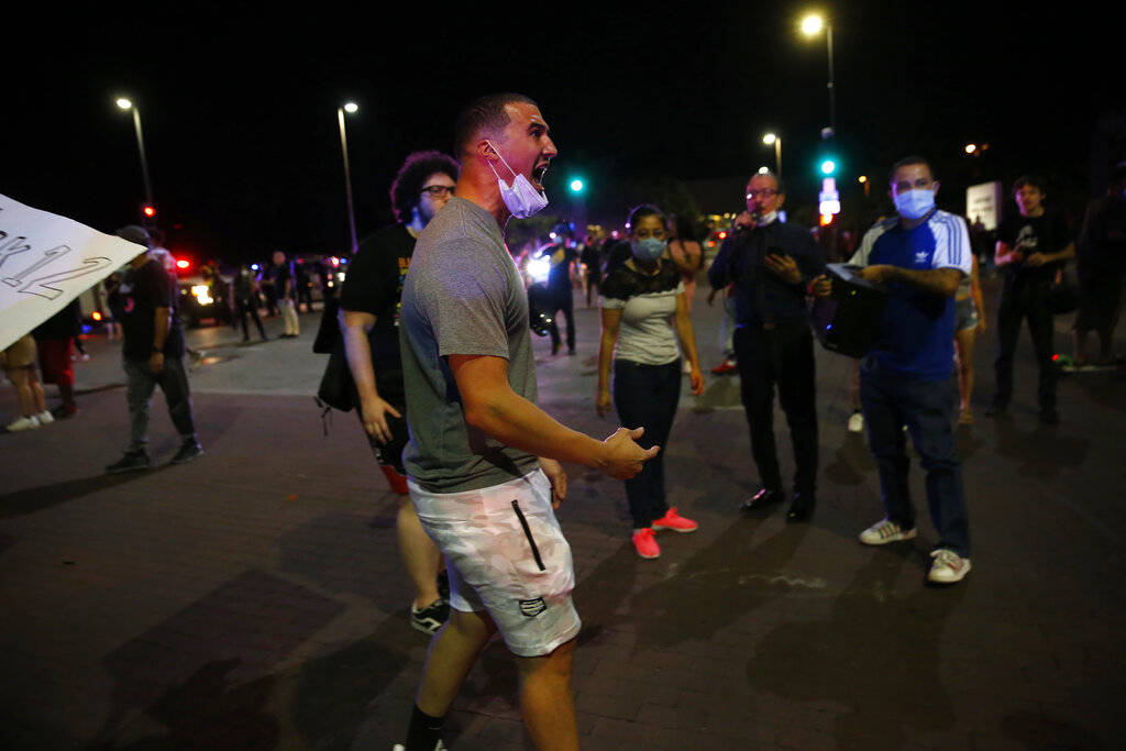 Protesters rally during a demonstration against police brutality in downtown Dallas, on Friday, ...