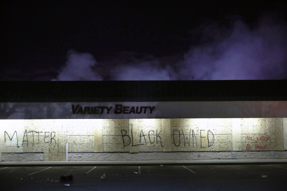 A business labeled "Black Owned" remains untouched by looters, Friday, May 29, 2020, ...