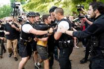 Uniformed U.S. Secret Service police detain a protester in Lafayette Park across from the White ...