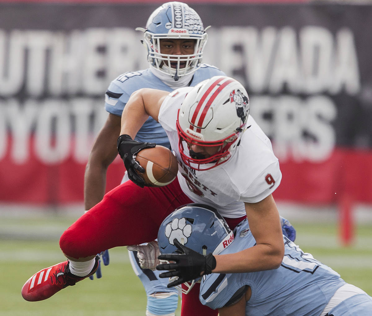 Liberty junior tight end Moliki Matavao (9) fights for yardage while being tackled by Centennia ...