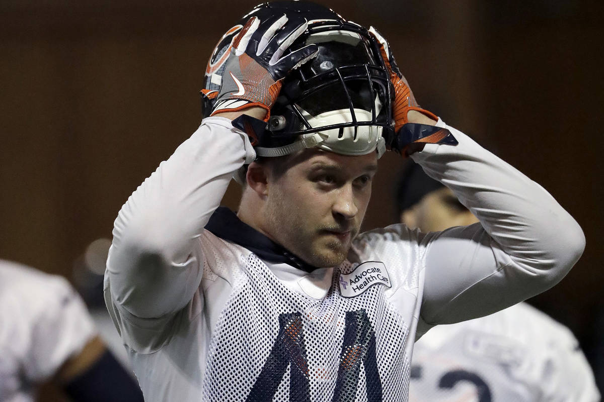 Chicago Bears linebacker Nick Kwiatkoski puts his helmet on during the NFL football team's volu ...