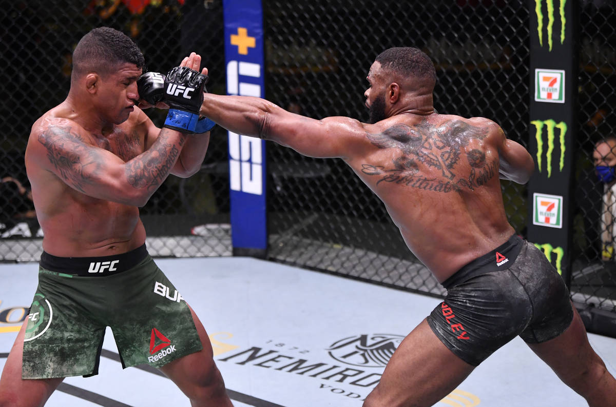 LAS VEGAS, NEVADA - MAY 30: (R-L) Tyron Woodley punches Gilbert Burns of Brazil in their welter ...