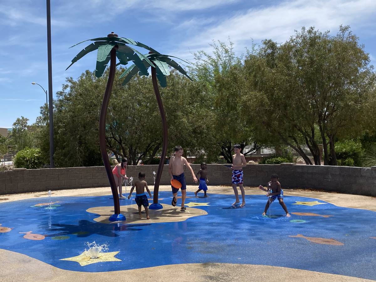 Children playing in the splash pad at Tropical Breeze Park in North Las