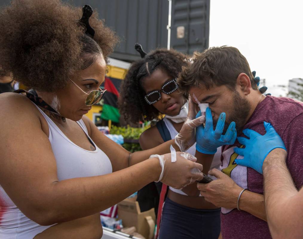 A protester is patched up after a fall during a Black Lives Matter protest and march at Contain ...