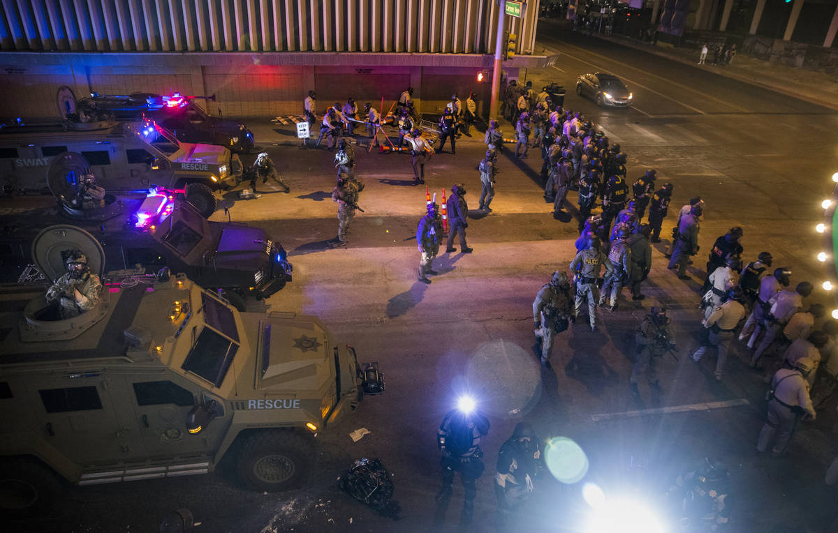 Las Vegas Police move down Las Vegas Blvd. towards protesters as chaos erupts during a Black Li ...