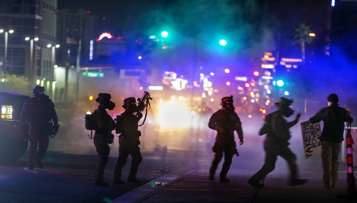 Las Vegas Police are engulfed in tear gas as they move in on a protester along Las Vegas Blvd. ...