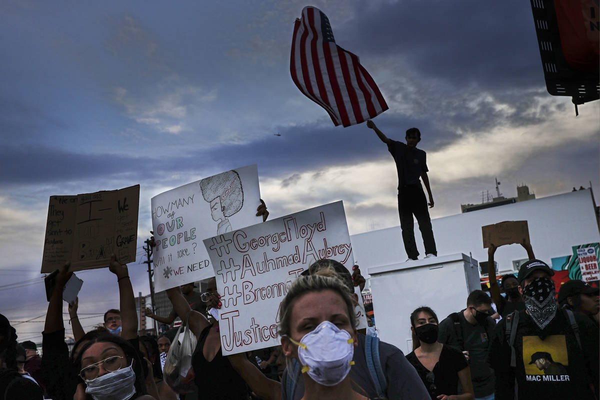 A protester waves an upside down U.S. flag the death of George Floyd in downtown Las Vegas on S ...