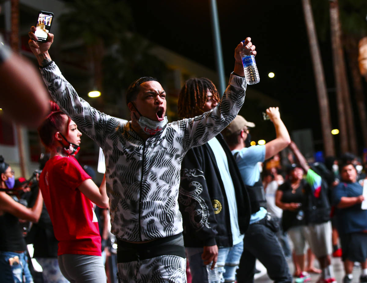 A man shouts at police while protesting the death of George Floyd in downtown Las Vegas on Satu ...